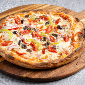 pizza with vegetables on a wooden plate